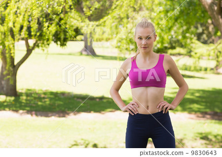 Healthy and beautiful woman in sports bra in park 9830643