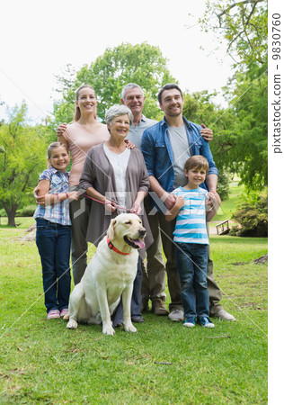 Happy extended family with pet dog at park 9830760