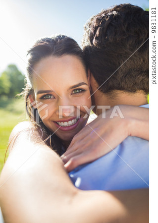 Loving and happy woman embracing man at park Loving and happy woman embracing man at park 9831181