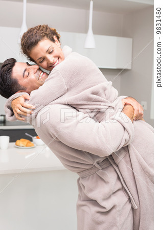 Man lifting and hugging his partner in the morning Man lifting and hugging his partner in the morning 9831480