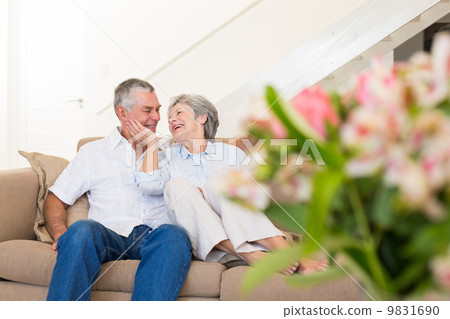 Loving senior couple on sofa Loving senior couple on sofa 9831690