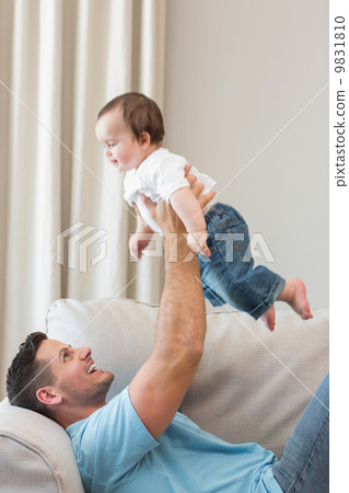 Happy father playing with cute baby 9831810