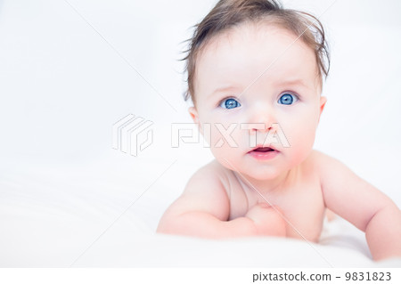 Lovely baby with blue eyes in bed Lovely baby with blue eyes in bed 9831823