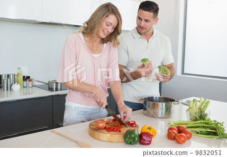Couple preparing food in kitchen Couple preparing food in kitchen 9832051