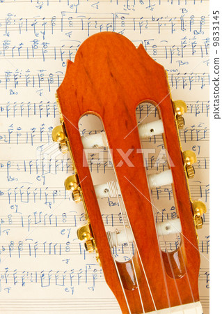 Old music sheet and a guitar Old music sheet and a guitar 9833145