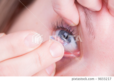 Close up of inserting a contact lens Close up of inserting a contact lens 9833217