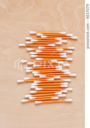 Ear sticks scattered on a table 9837079