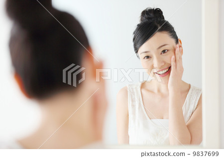 Woman looking in the mirror Woman looking in the mirror 9837699