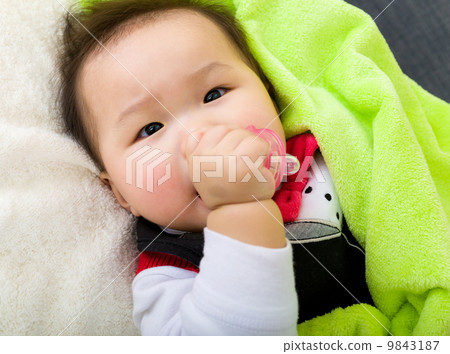 Asian baby sleeping on bed 9843187