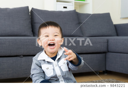 Asian little boy laugh in living room 9843221