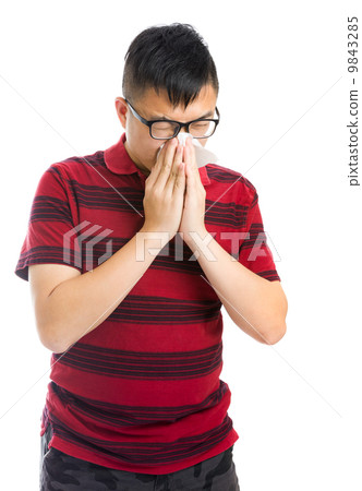 Asian man sneezing Asian man sneezing 9843285