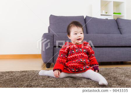 Baby girl doing legs splits on carpet 9843335
