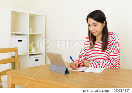 Asian woman learning through digital tablet 9843487