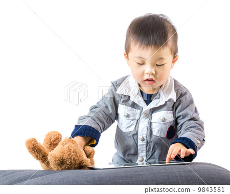 Asian baby touch the tablet 9843581