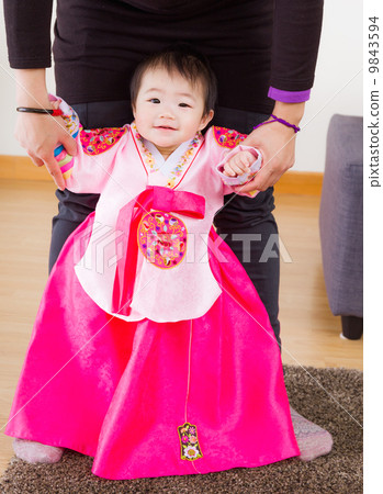 Traditional korean costume baby try to stand up 9843594