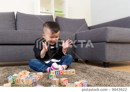 Little boy feeling excited to play toy block 9843622