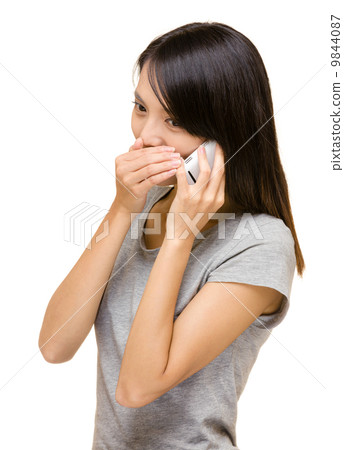 Asian woman talking secret on phone 9844087