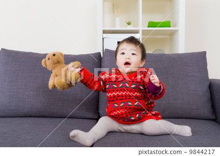Little girl play with doll 9844217