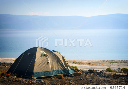 Camping tent in the nature by lake 9845714