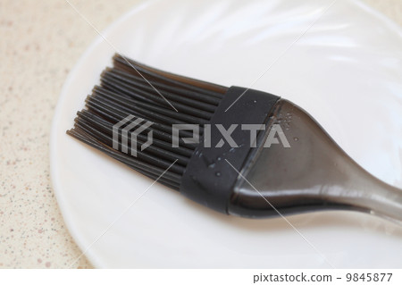 Black silicone pastry brush on white plate Black silicone pastry brush on white plate 9845877