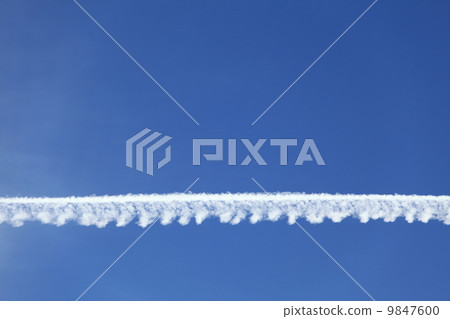 Airplane tracks in the blue sky 9847600
