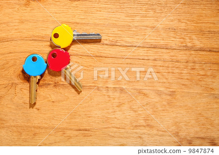 House keys with colorful plastic coats caps on table House keys with colorful plastic coats caps on table 9847874