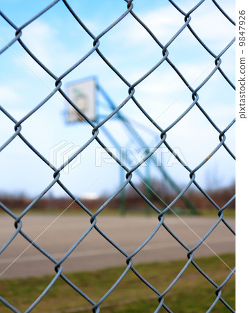 Metal mesh with blur basketball court background 9847926