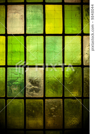 colored stained glass window with regular block pattern green tone colored stained glass window with regular block pattern green tone 9848044