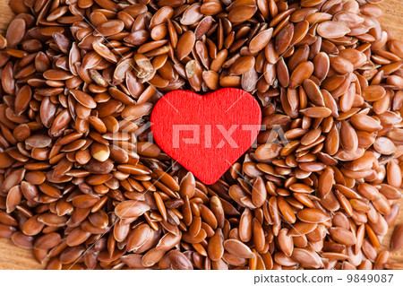 Healthy diet. Flax seeds linseed as food background and red heart 9849087