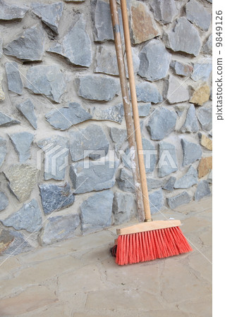 large broom on wall outdoor - housework 9849126