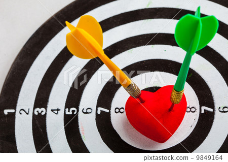 Black white target with two darts in heart love symbol as bullseye 9849164