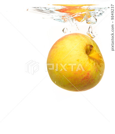 Yellow apple in the water splash over white 9849237