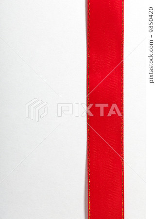 Shiny red ribbon on white background with copy space. 9850420