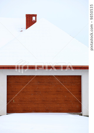 car garage door surrounded by snow car garage door surrounded by snow 9850535