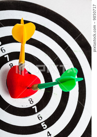 Black white target with two darts in heart love symbol as bullseye 9850717