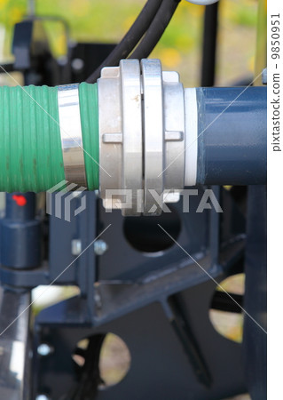 green plastic hose tube is connected to blue steel pipeline 9850951