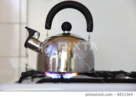 tea kettle on a flaming gas stove. tea kettle on a flaming gas stove. 9851564