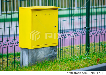 Yellow electric control box outdoor. Urban power and energy. 9851711