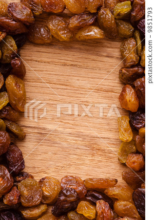 Diet healthy food. Border of raisin on wooden background 9851793