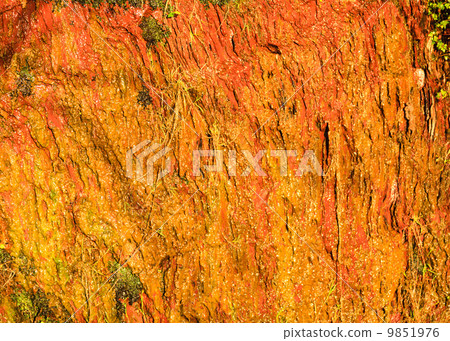Background of orange wet stone rock wall texture outdoor Background of orange wet stone rock wall texture outdoor 9851976