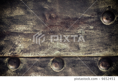 Grunge black metal plate with rivets screws background texture 9852451