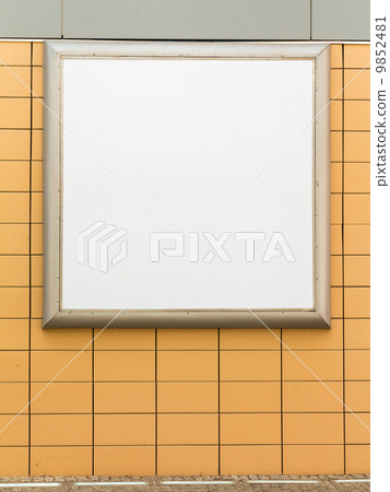 Empty blank square white advertising billboard on orange tiled wall Empty blank square white advertising billboard on orange tiled wall 9852481