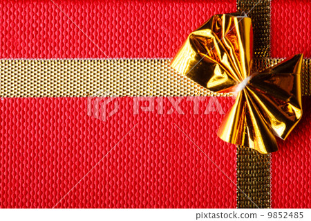 Giftbox closeup. Golden bow on red background Giftbox closeup. Golden bow on red background 9852485