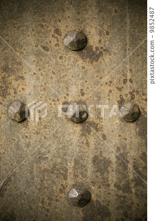 Brown grunge metal plate or armour texture with rivets Brown grunge metal plate or armour texture with rivets 9852487