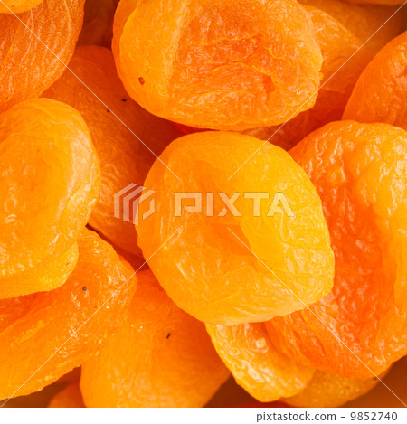 Heap of dried apricots close-up food background 9852740