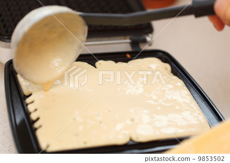 Waffle iron preparing waffles in kitchen Waffle iron preparing waffles in kitchen 9853502
