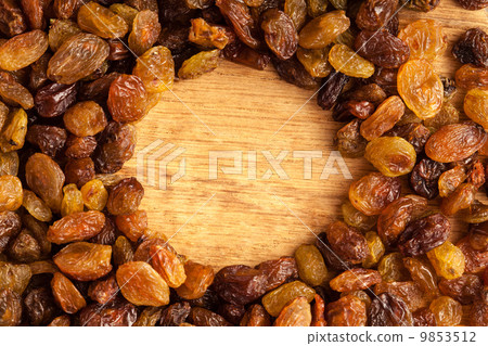 Diet healthy food. Border of raisin on wooden background 9853512