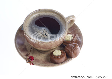 chocolate pralines cup with black coffee on white chocolate pralines cup with black coffee on white 9853518