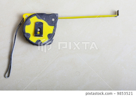 tape measure on concrete floor. Build concept. tape measure on concrete floor. Build concept. 9853521