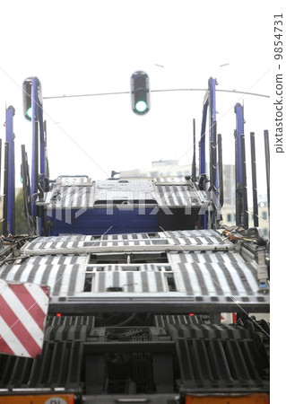 Empty car carrier truck on city road 9854731